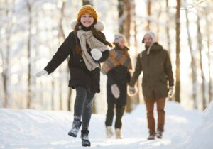 Family Walking in Snowy Woods