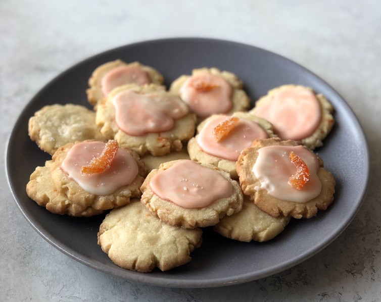 Gray Plate with a Pile of Cookies with Pink Frosting and Candied Grapefruit
