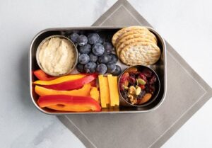 Bento Box with Veggies, Crackers, Hummus, Fruit