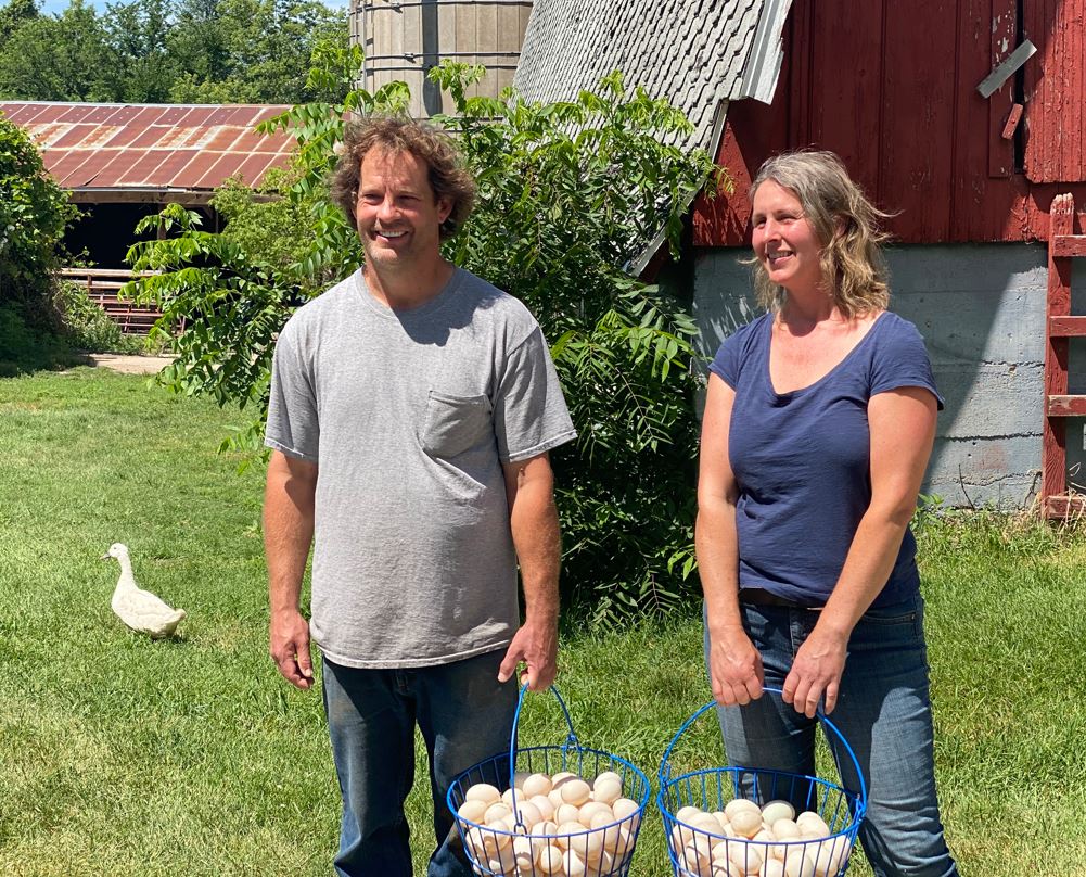 Farmers Hold Baskets Full of Eggs