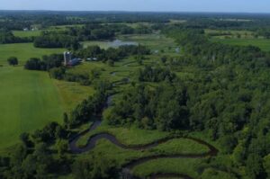 Farm and Winding River from Drone Shot Above