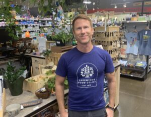 Wellness Department Manager Stands in Front of Counter