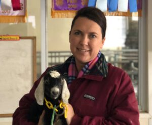 Woman Holding a Young Goat