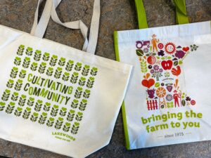 Image of two reusable tote bags with the Lakewinds Food Co-op brand.