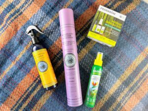 Various insect repellent products laying flat on a patterned blanket