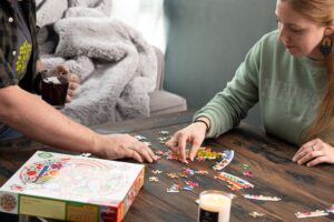 Two People Work on a Puzzle Together
