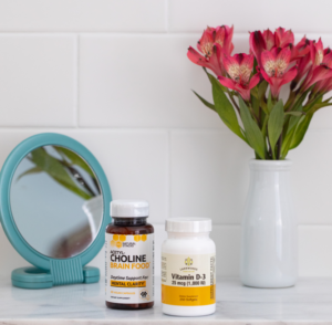 Bathroom with Small Mirror, Bouquet, and Two Supplement Bottles