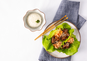 Kimchi on a Beef Lettuce Leaf Near Rice Bowl