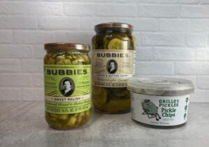 2 Jars of Bubbies Pickles and One Plastic Container of Grillo's Pickle Chips