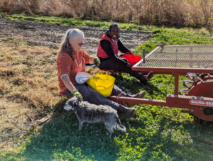 Two Women Sitting On Farm Equipment