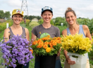 Three Women Holding Flowers