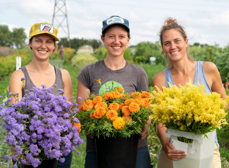 Three Women Holding Flowers