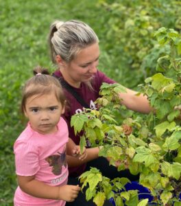 Woman and Little Girl Pick Berries