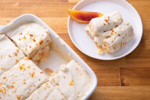 Baking Dish of Citrus Tiramisu with One Slice On a Plate