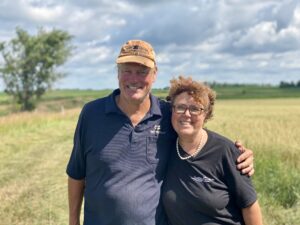 Farmers stand in field in sunshine