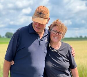 Farmers Stand in Field in Sunshine