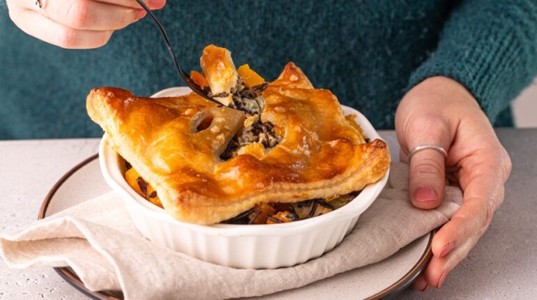 Person Lifting Fork From Potpie with Square Puff Pastry Topping