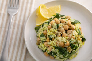 Mediterranean pilaf on a plate with lemon wedge with fork and napkin