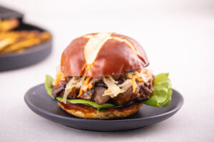 Burger Topped with Cheddar, Kimchi, Lettuce, on a Bun