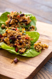 Red beans and rice lettuce wraps on wooden platter