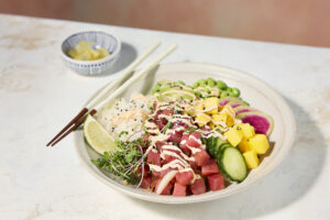 Poke bowl with chopsticks and ginger on the side