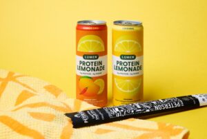 Lumen Protein Lemonades and Peterson Beef Stick on a Bright Yellow Background