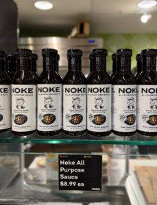 Noke's sauce lined up on a glass ledge shelf