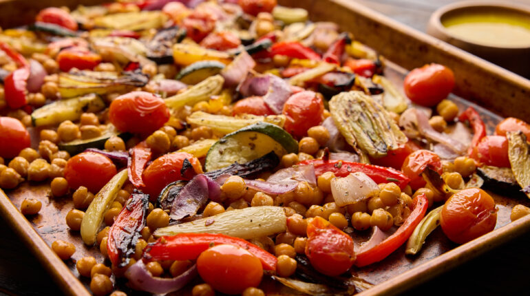 A Veggie-Filled Sheet Pan with a Small Bowl of Aioli on the Side